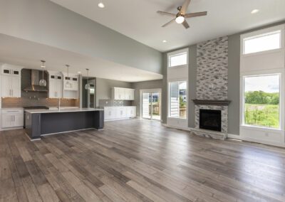 Spacious living area with modern kitchen, hardwood floors, and fireplace.